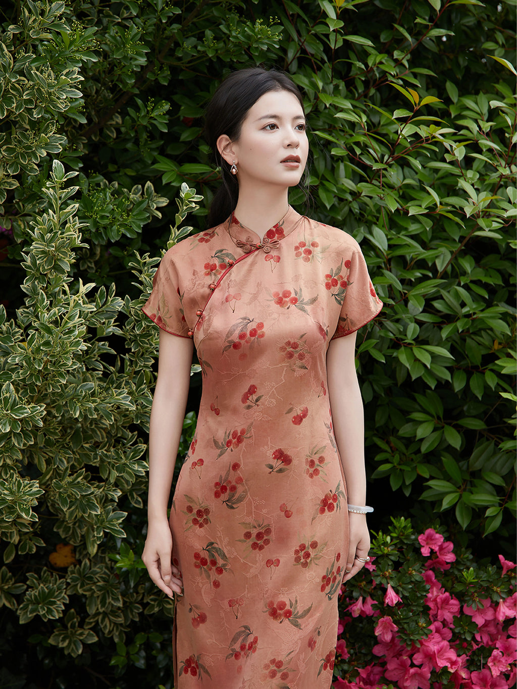 Close portrait of silk cheongsam dress with cherry blossom print