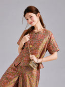 Detailed view of the multicolored pattern and relaxed silhouette of a Gambiered Silk two-piece set.