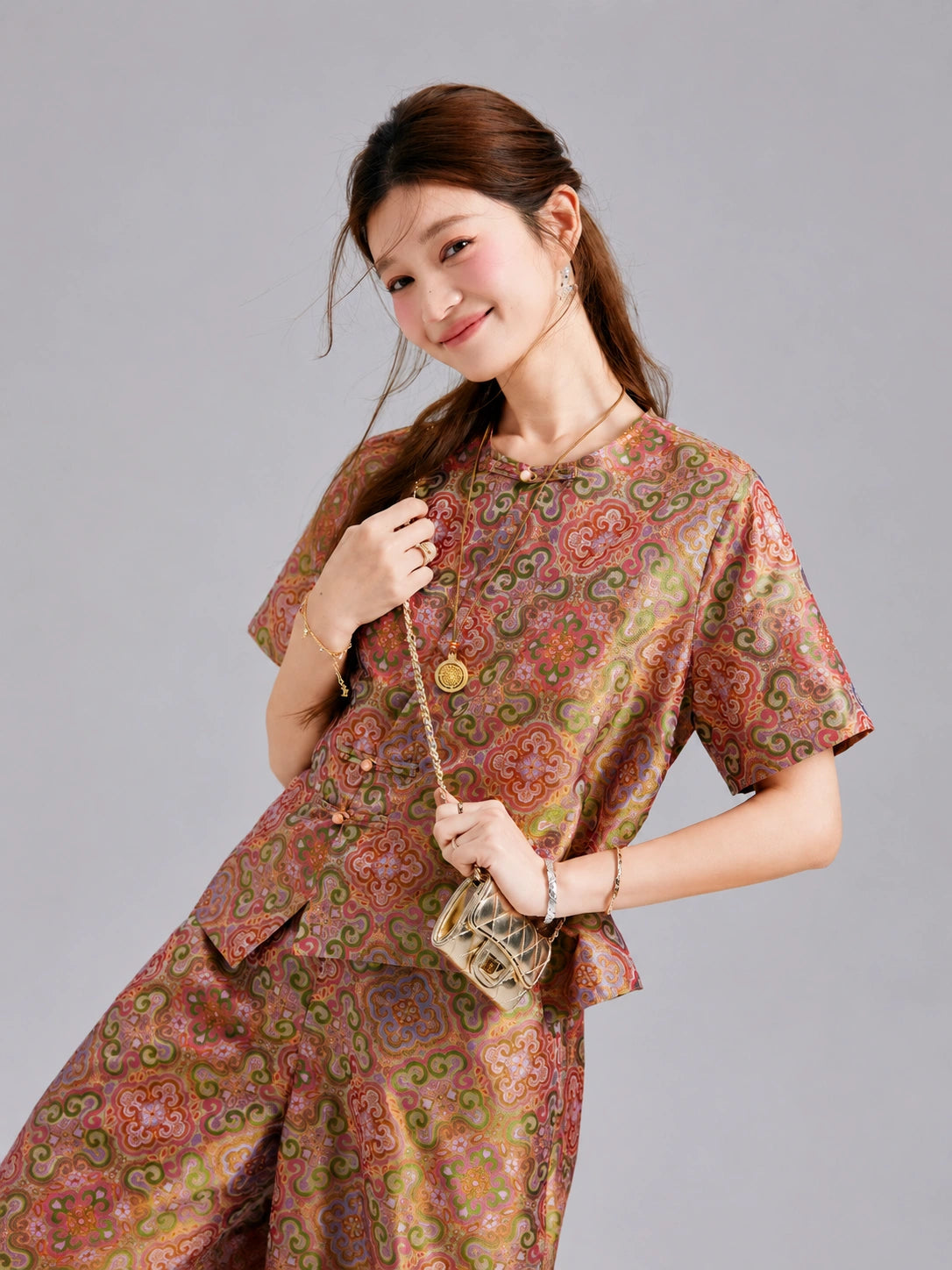 Detailed view of the multicolored pattern and relaxed silhouette of a Gambiered Silk two-piece set.