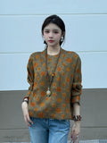 Front view of a model wearing a relaxed olive patterned silk pullover top