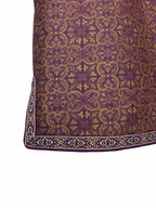 Close-up of the ornamental hem and contrast trim on a patterned mulberry silk jacket