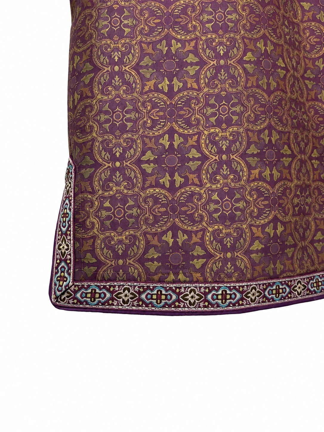 Close-up of the ornamental hem and contrast trim on a patterned mulberry silk jacket