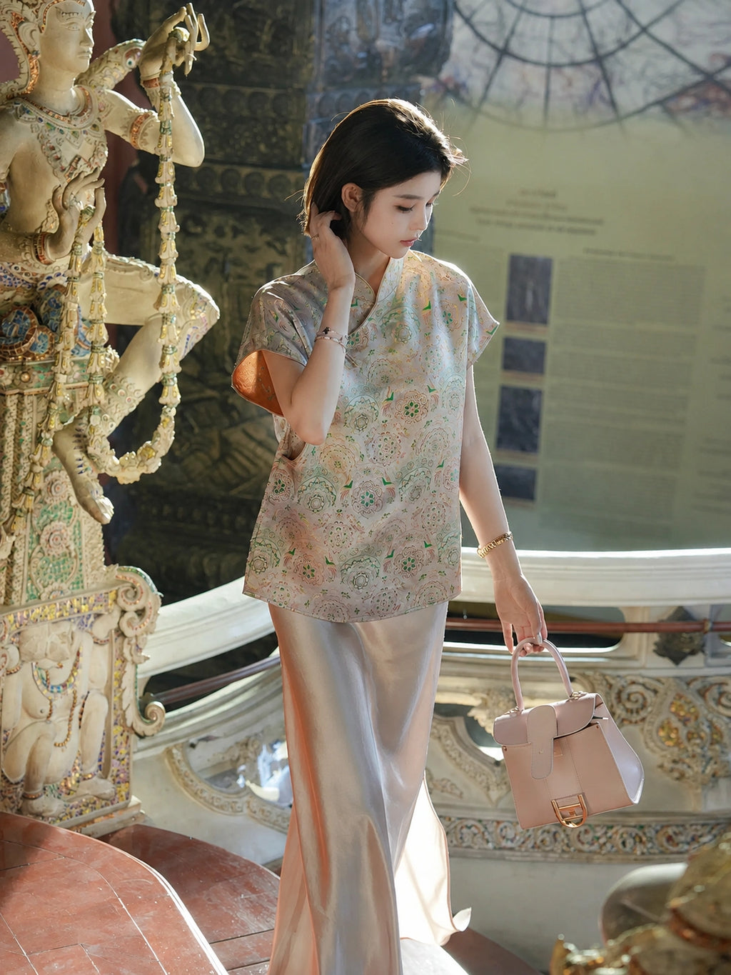 Model wearing a relaxed patterned silk-blend top with a cropped length