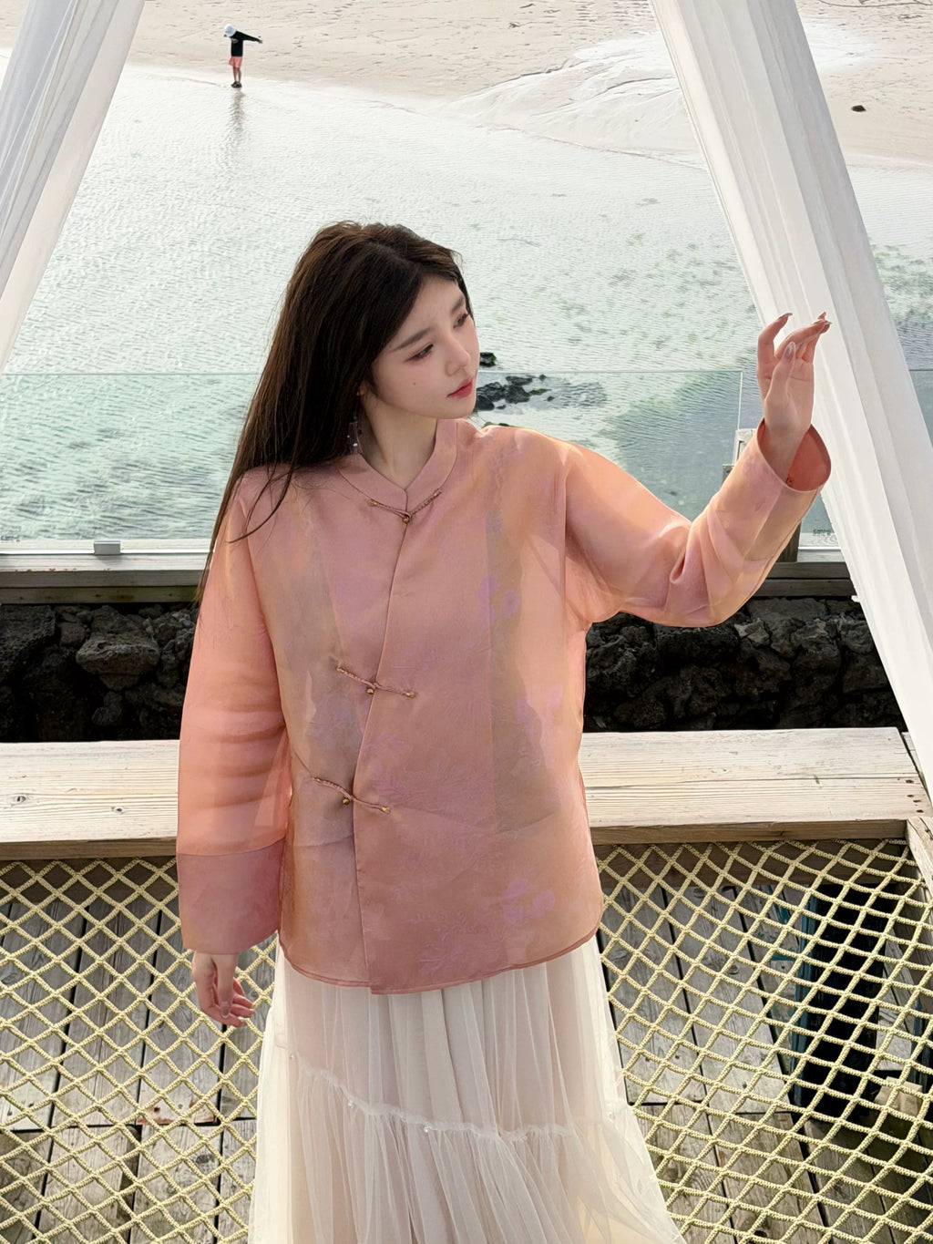 Front view of a floral-patterned mulberry silk top with a mandarin collar and frog closures