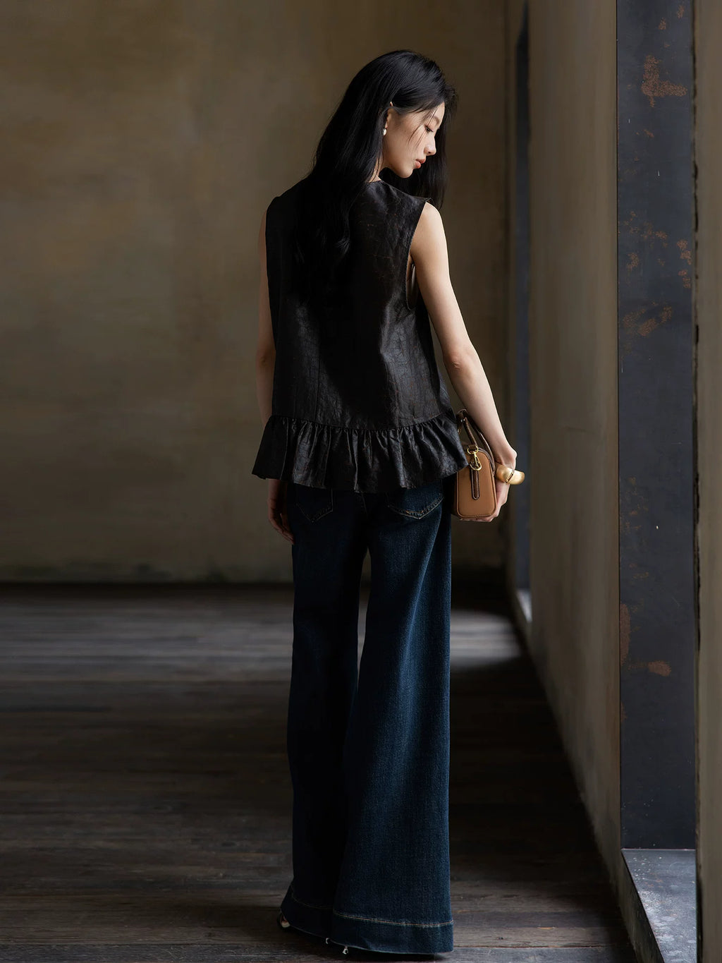 Back view of a women's sleeveless Gambiered Silk blouse with a softly gathered peplum hem.