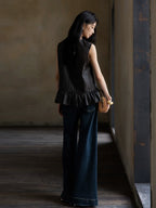 Back view of a women's sleeveless Gambiered Silk blouse with a softly gathered peplum hem.