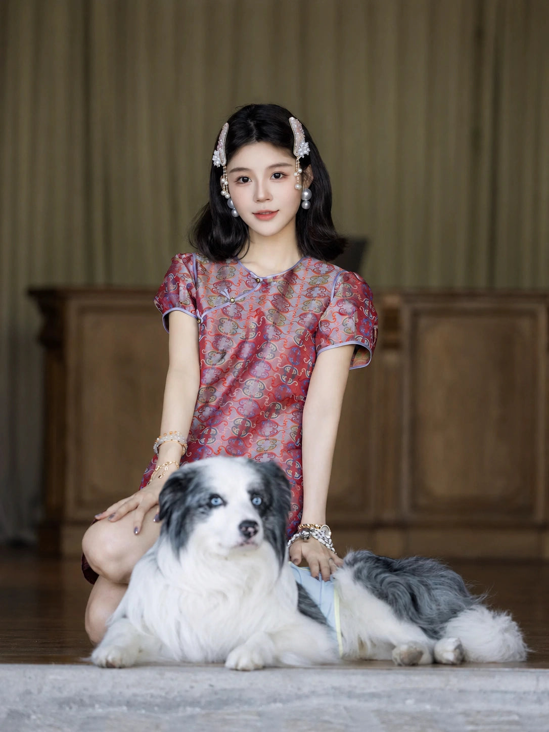 Model wearing a pink Chinese-style mulberry silk dress in a classic indoor lifestyle setting.
