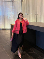 Front view of a pink Chinese-inspired silk jacket with decorative openwork detailing