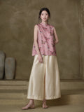 Model wearing the Gambiered Silk dusty pink horse-motif jacquard vest with ivory wide-leg trousers