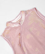 Blush-pink cut-velvet vest showing its Mandarin collar, asymmetric piping and decorative frog-button closures