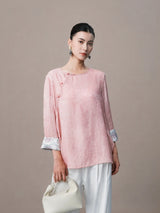 Model wearing pink viscose and mulberry silk blouse with relaxed fit.