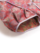 Close-up of the pink mulberry silk fabric showing the traditional-inspired pattern, piping, and Chinese knot detail.