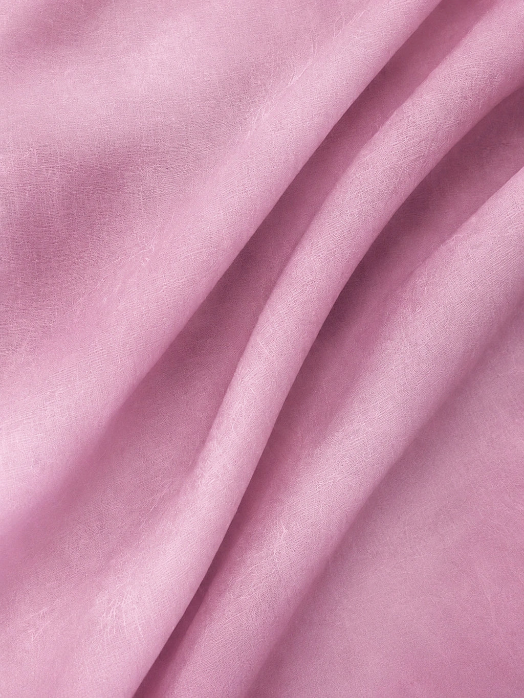 Close-up view of delicate pink mulberry silk organza fabric texture
