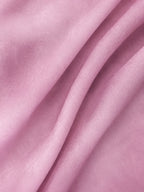 Close-up view of delicate pink mulberry silk organza fabric texture