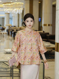 Model wearing a pink 28 momme mulberry silk Song Brocade top with three-quarter sleeves