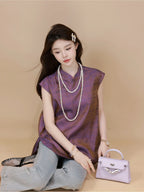 Model wearing a plum purple mulberry silk sleeveless top while seated