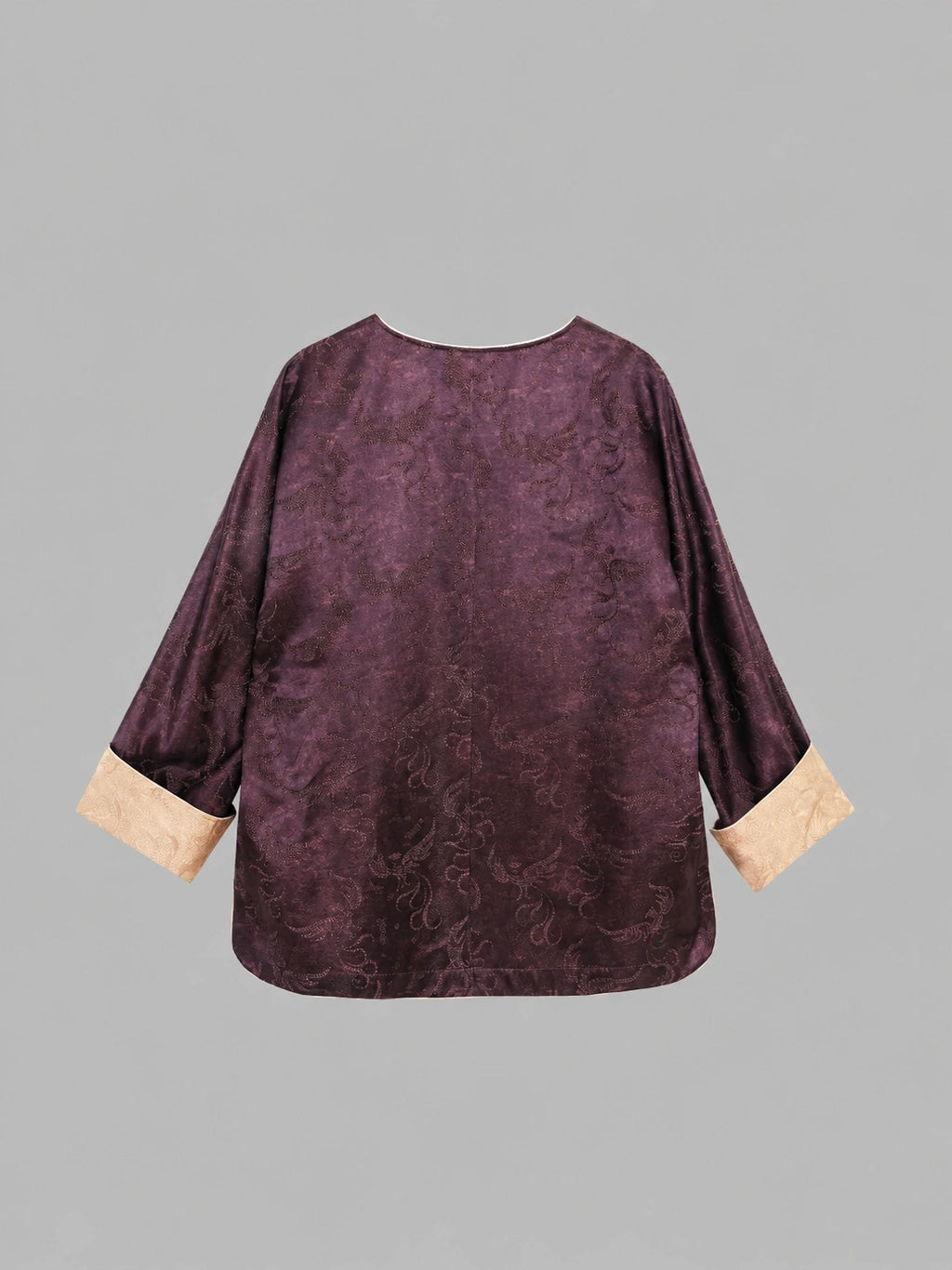 Back view of a plum silk-blend top with tonal paisley texture and contrasting sleeve cuffs