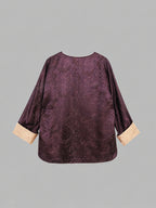 Back view of a plum silk-blend top with tonal paisley texture and contrasting sleeve cuffs