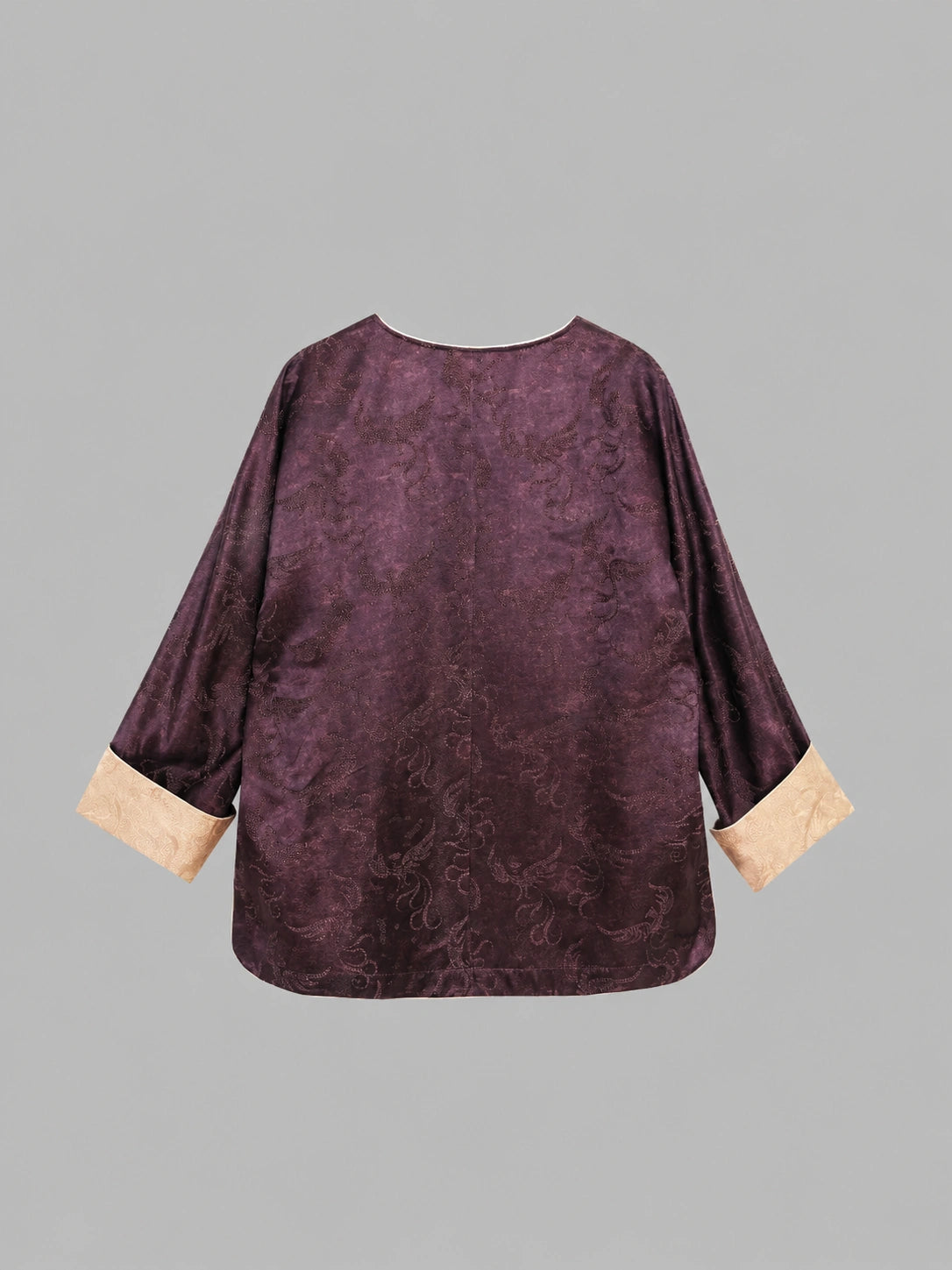 Back view of a plum silk-blend top with tonal paisley texture and contrasting sleeve cuffs