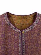 Close-up of the rounded neckline, decorative trim and button closure on a plum silk jacket