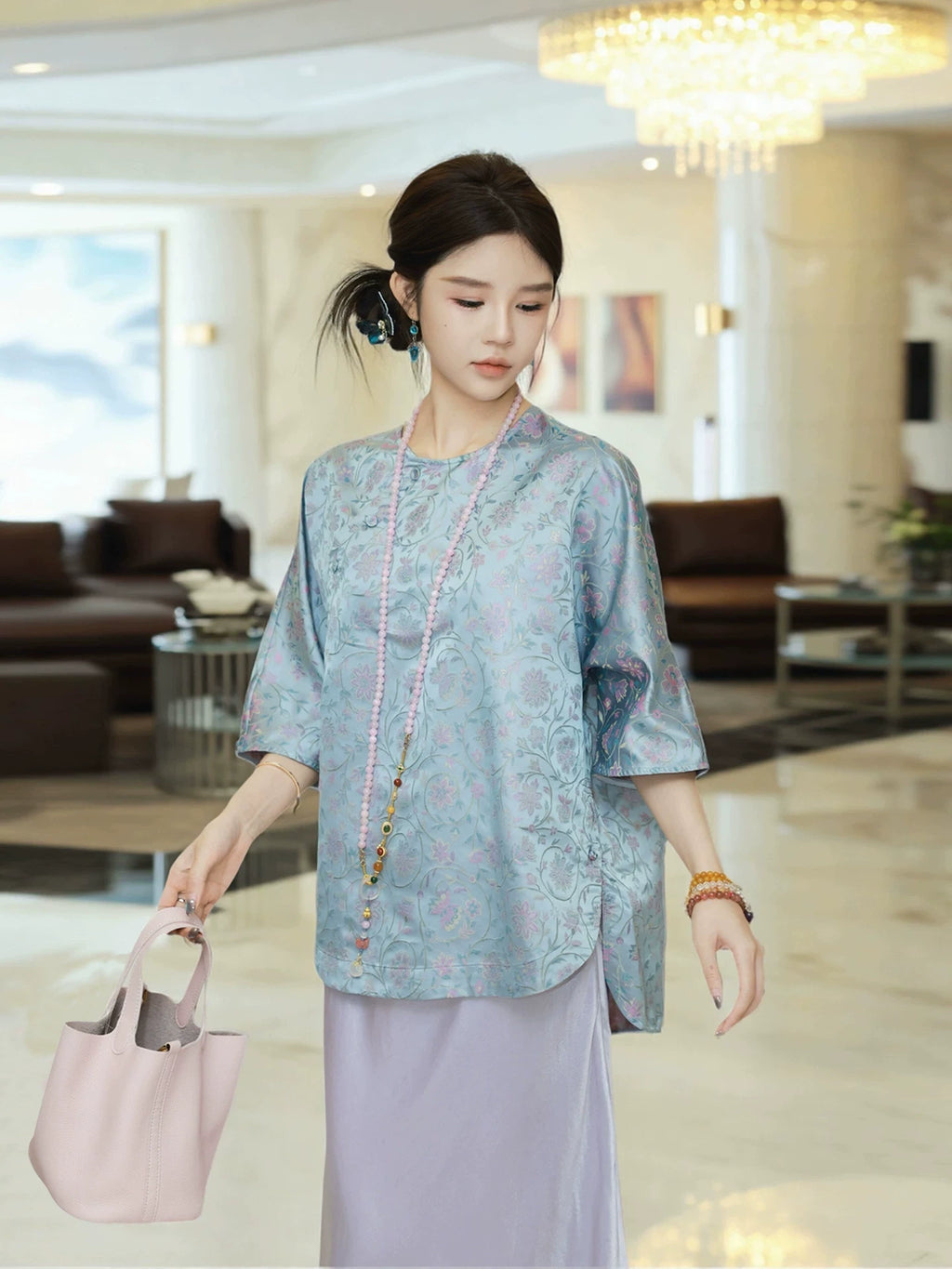 Model wearing a powder blue floral Song Brocade silk top with a relaxed fit