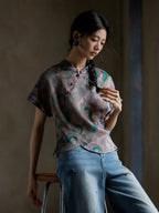 Woman wearing a 100% mulberry silk Gambiered Silk printed blouse with a mandarin collar and handmade frog buttons.