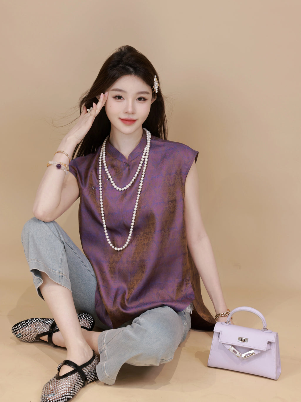 Side view of a plum purple mandarin-collar silk top with a relaxed silhouette