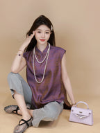 Side view of a plum purple mandarin-collar silk top with a relaxed silhouette