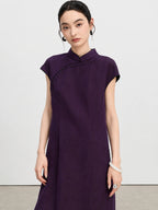 Close view of a woman wearing a purple crackle-textured silk qipao dress with black bead detailing.