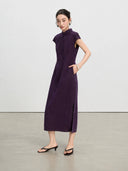 Full-length view of an aubergine New Chinese qipao dress with side pockets and a side slit.