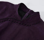 Close-up of the Mandarin collar, black piping and bead embellishment on a purple silk qipao dress.