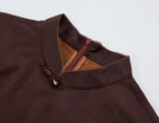 Close-up of the stand collar, gemstone knot closure, contrast piping and concealed back zipper