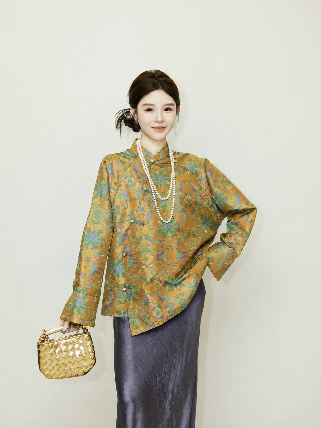 Full look featuring a model wearing a loose patterned reversible mulberry silk jacket with a dark skirt
