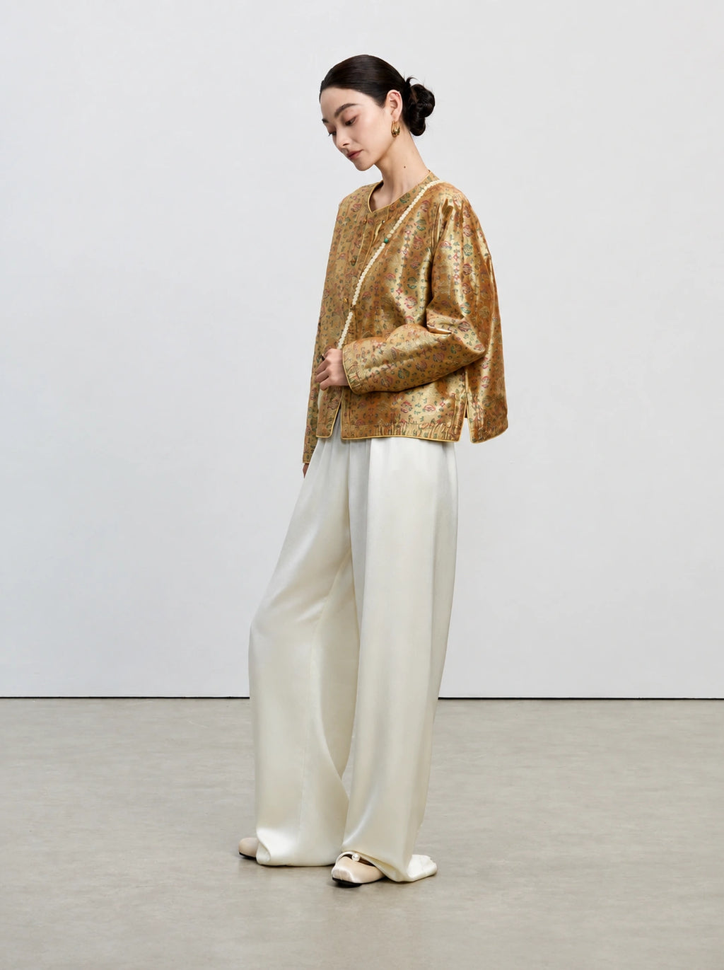 Side view of the antique gold 33 momme reversible mulberry silk Shu brocade jacket.