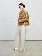Side view of the antique gold 33 momme reversible mulberry silk Shu brocade jacket.