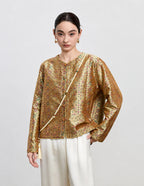 Front detail of the antique gold reversible silk jacket with a round neckline and decorative buttons.