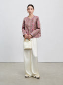 Full-length front styling of the dusty mauve reversible Shu brocade silk jacket.