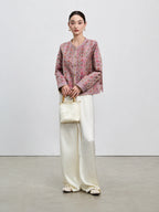 Full-length front styling of the dusty mauve reversible Shu brocade silk jacket.