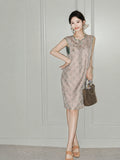 Woman wearing the blush-pink side of the reversible Song brocade silk dress with green trim.