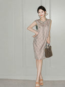 Woman wearing the blush-pink side of the reversible Song brocade silk dress with green trim.