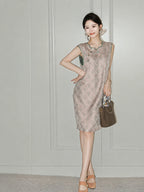 Woman wearing the blush-pink side of the reversible Song brocade silk dress with green trim.