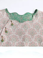 Neckline detail of the reversible pink and jade-green Song brocade silk dress.