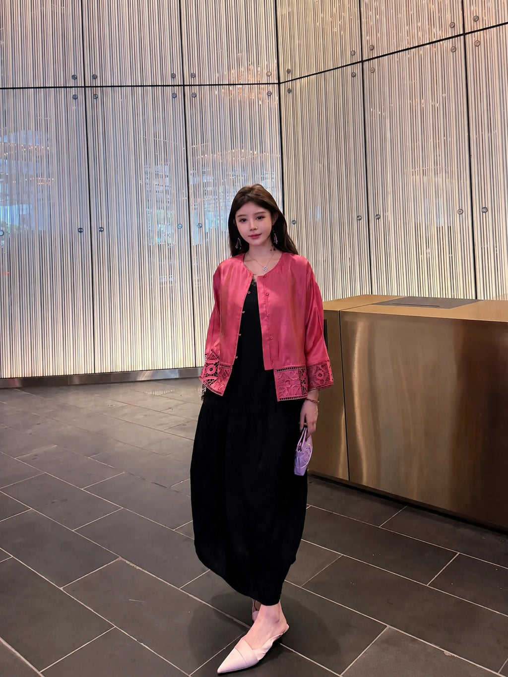 Model wearing a rose pink mulberry silk jacket with openwork cuffs and hem