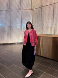 Model wearing a rose pink mulberry silk jacket with openwork cuffs and hem