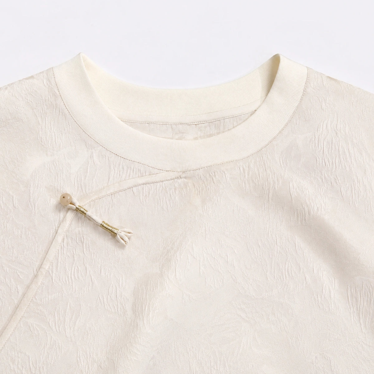 Close-up of the round neckline and diagonal Chinese-style closure