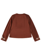 Back view of a rust-brown mulberry silk jacket with ivory embroidery at the cuffs.