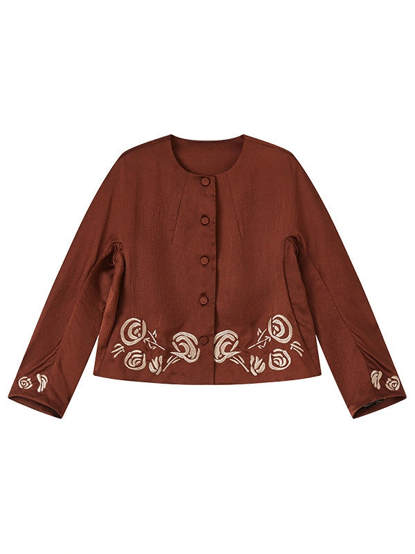 Front view of a rust-brown gambiered silk jacket with ivory embroidery and covered buttons.