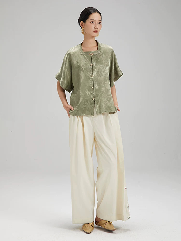Angled view of the Sage Green Jacquard Mandarin Collar Blouse highlighting its flowing silhouette and jacquard texture.