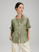 Close-up of the Sage Green Jacquard Mandarin Collar Blouse showcasing the textured fabric and decorative frog button closure.