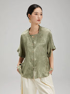 Close-up of the Sage Green Jacquard Mandarin Collar Blouse showcasing the textured fabric and decorative frog button closure.
